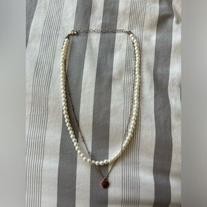 pearl and gold necklace with a pendant